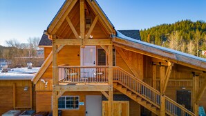 A wooden cabin with a balcony, a staircase, and a door marked with the number 3. - Views of the Mountain from the private decks of this upstairs condo. (Pinehurst)