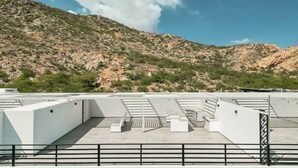 A rooftop terrace with a view of a mountainous landscape. - CONDO LI BY TRVL2HM (Cabo San Lucas)