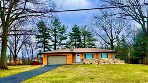 A single-story house with a garage, a front yard, and a driveway.
