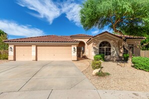 A single-story house with a tiled roof, a garage, and a front entrance with a window. - Beautiful,Immaculate, Glendale home. (Glendale)