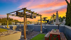 A rooftop patio with a pergola, seating, and a table. - ★Insta-Worthy Sunset View ★Private Rooftop ★Garage ★Silver Lake ★Dodgers Stadium (Los Angeles)