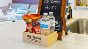 A kitchen counter with a welcome sign, popcorn, bottled water, and a message about living each day as if it were your last. - ★Insta-Worthy Sunset View ★Private Rooftop ★Garage ★Silver Lake ★Dodgers Stadium (Los Angeles)