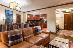 Cozy living space with a leather sofa, dining area, and kitchenette.