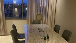 A modern dining room with a rectangular table, six chairs, and a decorative fan. - Cosy, upscale apartment in California (Casablanca)