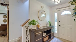 A modern entryway with a dark wooden console, a welcome sign, a mirror, and a potted plant. - Farmhouse w/ Private Hot Tub < 1 Mile to Birch Bay (Blaine)