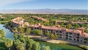 A resort with multiple buildings, a central courtyard, and a river.