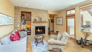 A living room with a fireplace, a sofa, a chair, and a coffee table. - Gorgeous Granita Ski in/Ski out (Telluride)