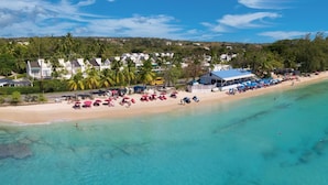 A coastal hotel with beach access, a boat dock, and a view of the ocean. - Forest Hills 23 | Beach View - Located in  Wonderful Saint James with House Cleaning Included (Saint James)
