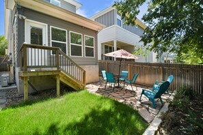 Enjoy al fresco dining on the patio with a round table and comfortable seating for four.