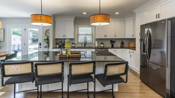 A modern kitchen with a central island, black chairs, a stainless steel refrigerator, and pendant lighting. - Great Location / Keeneland / Rupp / Fenced Yard / Games (Lexington)