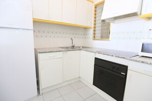 Fridge, oven, coffee/tea maker, cookware/dishes/utensils