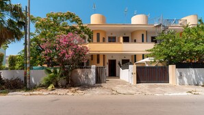 A two-story house with a gated entrance, a staircase leading to the second floor, and a small porch area. - 3055 Villetta Sunset by Barbarhouse (Gallipoli)