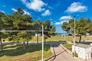 A street with trees, a utility box, and a street lamp. - 2719 Villino Isidoria by Barbarhouse (Nardò)