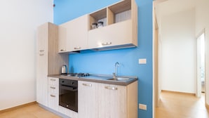 A compact kitchen with light wood cabinets, a built-in stove, and a sink. - 2719 Villino Isidoria by Barbarhouse (Nardò)