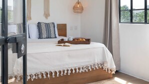 A bedroom with a bed, a ceiling fan, a window with curtains, and a hanging light fixture. - Amazing Villa in la Veleta 14 pax (Tulum)