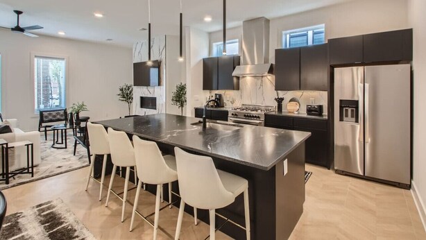 A modern kitchen with a central island, stainless steel appliances, and pendant lighting. - 4 - Music Row Modern - The Music City Collection (Nashville)