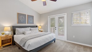 A bedroom with a bed, nightstands, a ceiling fan, and a window with blinds. - Red Barn Roost • Cozy Stay Near Downtown (Loveland)
