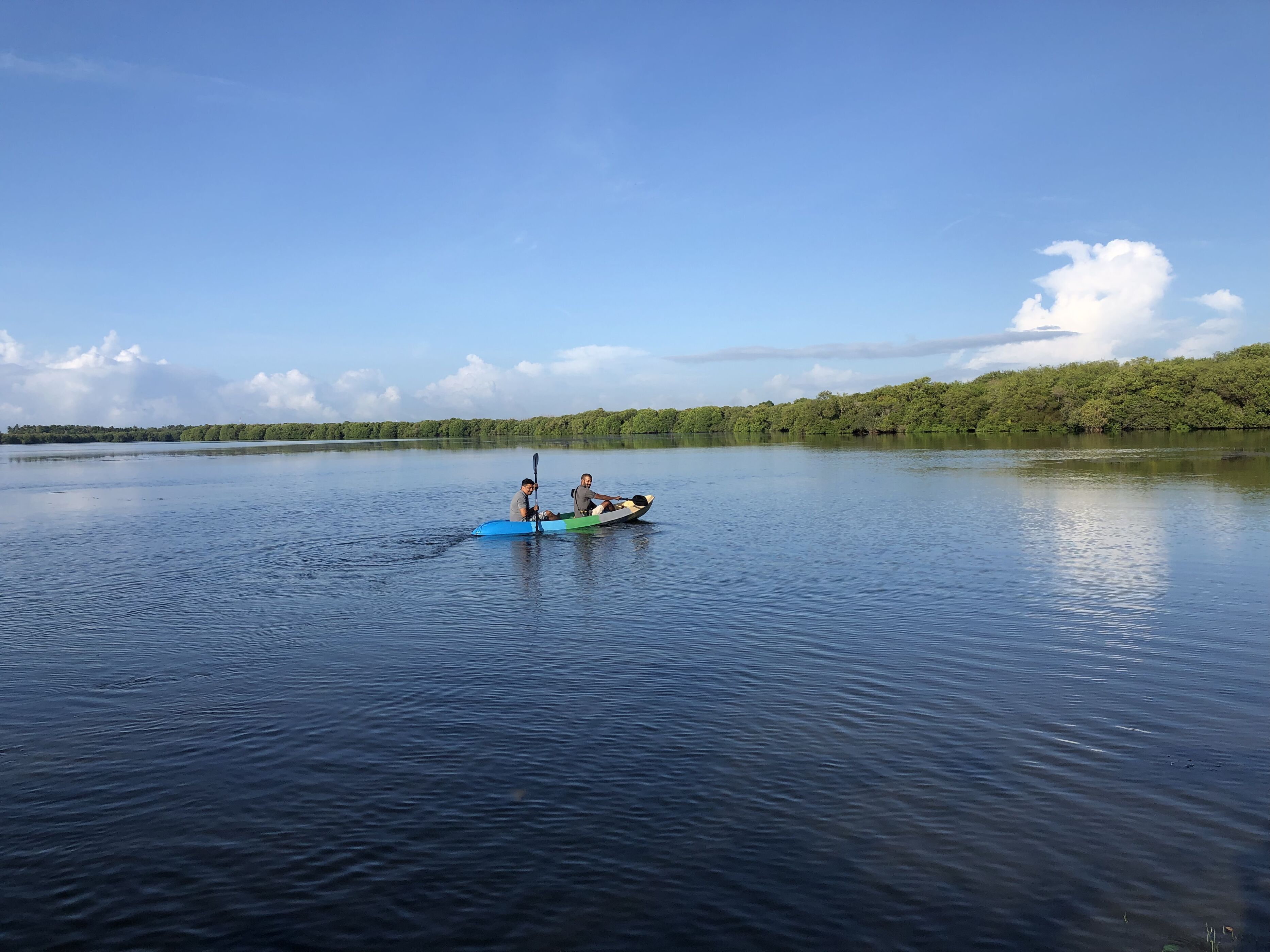 A calm lake with two kayaks on the water.