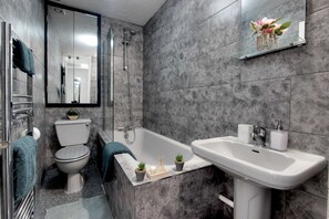 Combined shower/bathtub, hair dryer, towels, soap