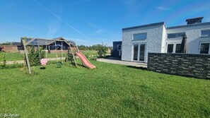 Enjoy a family-friendly stay in this two-story house with a play area featuring a swing set and slide.
