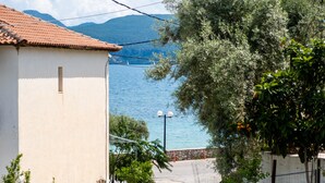 A coastal view with a building, a clear sky, and a body of water. - Apartment "Nikoleta 1" with Sea View, Terrace & Wi-Fi (Lefkada)
