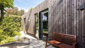 A wooden exterior wall with a bench and a door. - Zandvoort Lodge 1 - Amazing couples getaway! (Zandvoort)