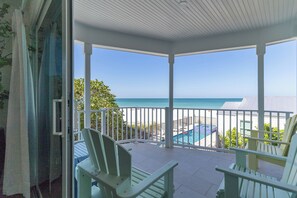 A covered outdoor area with white railings, a pool, and a view of the ocean. - Turtle Watch: *Gulf front *Heated Pool *Spectacular Views (Holmes Beach)
