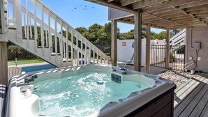 A hot tub with a wooden deck and a white fence. - Serenity Shores: 125ft. to Beach | Private Pool (Southern Shores)