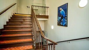 A staircase with wooden steps and a glass railing, leading to an upper floor. - Banana's Camp - Hostel (Cannes)