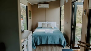 A bedroom with a bed, a desk, and a window. - Nomad Nation by Tiny Away (Mount Perry)