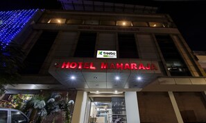 The exterior of Hotel Maharaja Residency with illuminated signage and a modern facade. - Treebo Maharaja Residency Family Hotel (Jaipur)