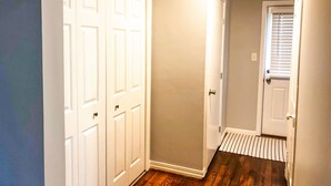 A hallway with a wooden floor, white doors, and a small rug leading to another room. - Minutes from the Ark Encounter! (Dry Ridge)