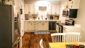 A kitchen with white cabinets, a refrigerator, a microwave, and a coffee maker. - Minutes from the Ark Encounter! (Dry Ridge)