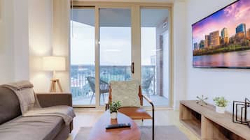 Comfort Apartment, 1 Bedroom, City View | Living area | 50-inch Smart TV with cable channels, TV