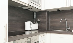 Fridge, stovetop, dishwasher, coffee/tea maker