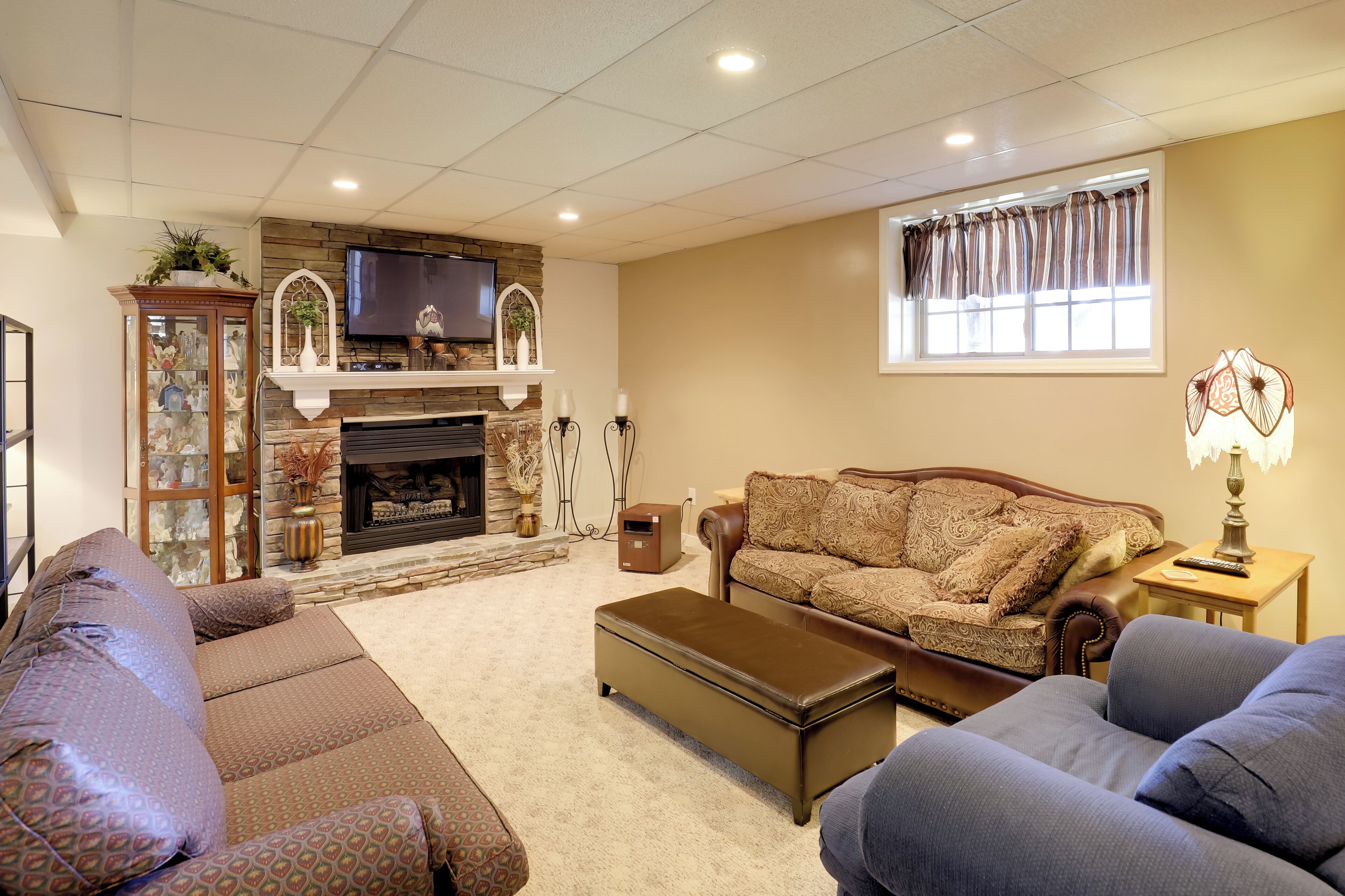 A living room with a fireplace, a television, a sofa, and a coffee table.