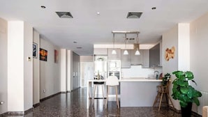 A modern kitchen with granite countertops, stainless steel appliances, and pendant lighting. - Modern flat with sea views in Valencia. (Valencia)