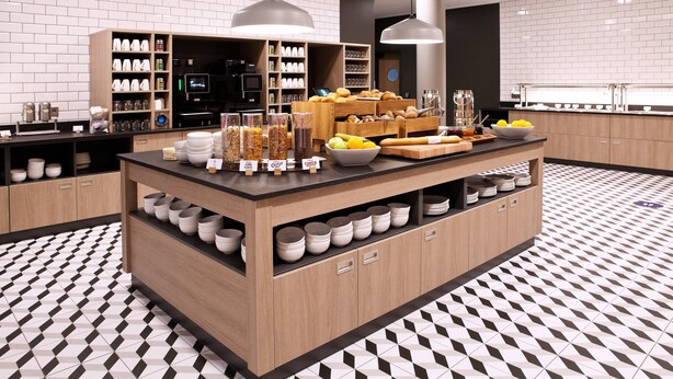 Una cocina moderna con una isla central, armarios de madera y piso estampado.