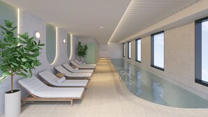 A modern indoor pool area with lounge chairs and potted plants. - Holiday Inn & Suites Geelong by IHG (Geelong)