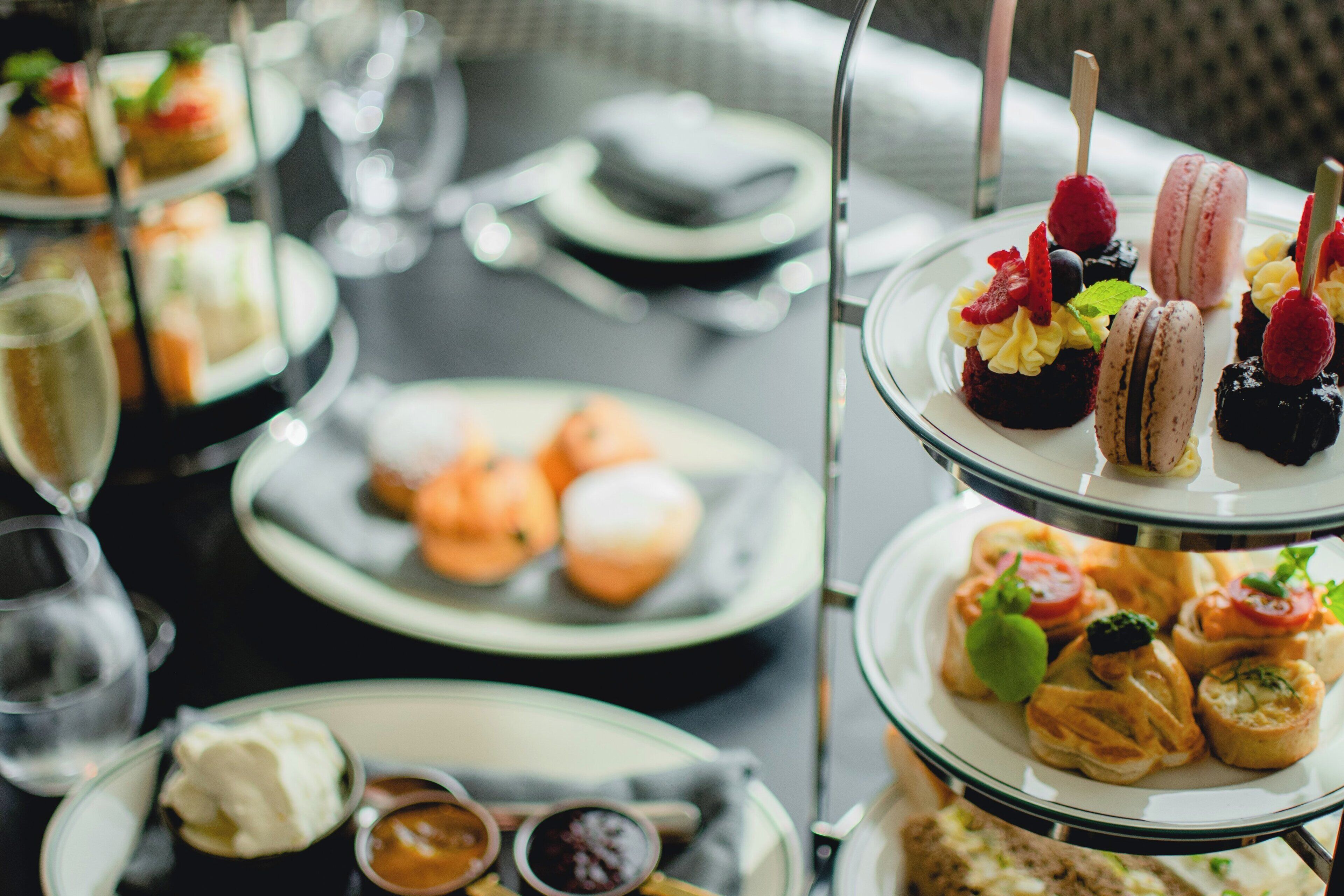 A multi-tiered dessert display with various pastries and fruits.