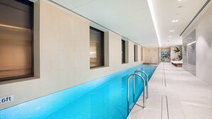 A long indoor swimming pool with clear blue water, tiled walls, and a 6ft depth marker. - Holiday Inn & Suites Geelong by IHG (Geelong)