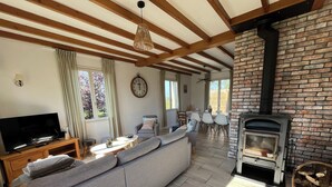 A living room with a sofa, TV, and a fireplace.