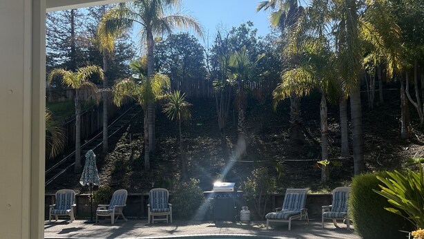 A backyard with a swimming pool, lounge chairs, and a barbecue grill. - Cheerful house 3 bed 4 bath pool house (Antioch)