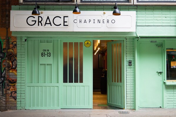 Un bâtiment vert sur lequel on peut lire l’inscription « GRACE CHAPINERO ».