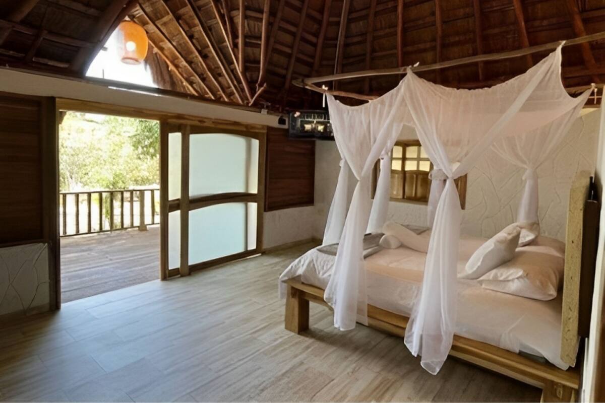 A room with a wooden ceiling and a bed with a canopy.