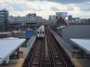 Trains arrive at this bustling railway station surrounded by urban buildings.