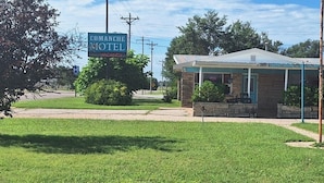 A small, single-story building with a sign indicating it is the Comanche Hotel. - Comanche inn (Coldwater)