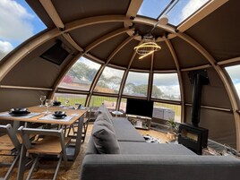 Un ambiente acogedor con una mesa de comedor, sillas, un sofá y una chimenea.