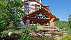 A resort building with a distinctive wooden structure and a sign indicating it is Smoky Mountain Resort.