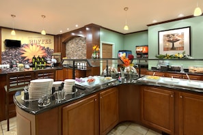 Enjoy a sumptuous spread at our buffet, featuring a variety of dishes and condiments.